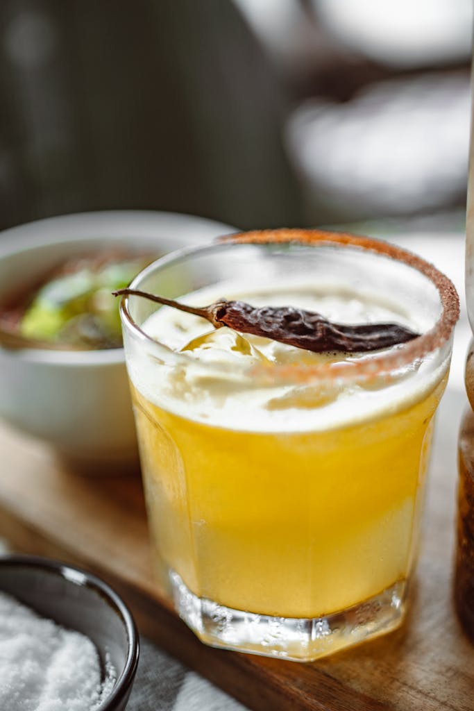 A tantalizing citrus cocktail garnished with dried chili, perfect for a spicy twist.